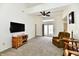 Bright living room featuring carpeted floors, neutral walls, ceiling fan and sliding glass doors at 1507 Park Dr, Lebanon, IN 46052