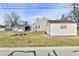 View of beige shed and yard, situated at the rear of a house and neighborhood on a sunny day at 1507 Park Dr, Lebanon, IN 46052