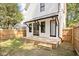 Backyard with a wood deck featuring a white home exterior with black trim windows at 1526 Laurel St, Indianapolis, IN 46203