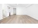 Spacious basement featuring light hardwood floors, a mini bar, and white walls at 1526 Laurel St, Indianapolis, IN 46203