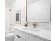 Bathroom featuring marble counters, a large mirror, and modern bronze fixtures at 1526 Laurel St, Indianapolis, IN 46203