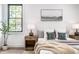 Serene bedroom features a decorative headboard, wood nightstands, and natural light at 1526 Laurel St, Indianapolis, IN 46203