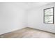 Bright bedroom featuring light hardwood floors, a ceiling fan, and a window providing natural light at 1526 Laurel St, Indianapolis, IN 46203
