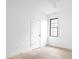 An empty bedroom with a ceiling fan, hardwood floor, and black frame window at 1526 Laurel St, Indianapolis, IN 46203