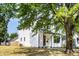Beautifully renovated home with stylish black window trim, a wood front door, and a well-maintained lawn at 1526 Laurel St, Indianapolis, IN 46203