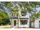 Charming two-story home with white siding, black trim, and a welcoming wood front door at 1526 Laurel St, Indianapolis, IN 46203