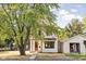 Charming two-story home with white siding and large tree, showcasing curb appeal at 1526 Laurel St, Indianapolis, IN 46203