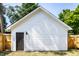 Exterior view of a white garage featuring a dark trim door at 1526 Laurel St, Indianapolis, IN 46203