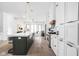 Bright kitchen with island seating, stainless steel appliances, and hardwood floors at 1526 Laurel St, Indianapolis, IN 46203