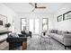 Bright living room with modern decor, stylish rug, and a ceiling fan at 1526 Laurel St, Indianapolis, IN 46203