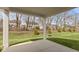 Inviting backyard view from the covered patio, showcasing lush green grass and mature trees at 16771 Cattle Hollow Ln, Noblesville, IN 46060
