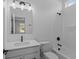 Bright bathroom featuring a bathtub with shower, sink, and window with neighborhood view at 16771 Cattle Hollow Ln, Noblesville, IN 46060