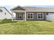 Rear exterior of the house features a covered patio and large windows overlooking the lawn at 16771 Cattle Hollow Ln, Noblesville, IN 46060