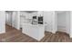 Contemporary kitchen boasting white cabinetry, a large island with a sink, and stainless steel appliances at 16771 Cattle Hollow Ln, Noblesville, IN 46060