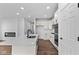 Bright kitchen featuring white cabinets, quartz countertops, stainless steel appliances, and a large island at 16771 Cattle Hollow Ln, Noblesville, IN 46060