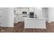 Modern kitchen with white cabinetry, stainless steel appliances, an island with a sink, and wood-look floors at 16771 Cattle Hollow Ln, Noblesville, IN 46060