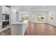 Kitchen island with sink, stainless steel appliances and wood floors at 16771 Cattle Hollow Ln, Noblesville, IN 46060