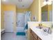 Yellow bathroom features a shower over tub, a vanity and a white tile floor at 18357 Piers End Dr, Noblesville, IN 46062