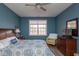 A well-lit primary bedroom features hardwood floors, a ceiling fan and a sunny window at 18357 Piers End Dr, Noblesville, IN 46062