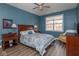 A well-lit primary bedroom features hardwood floors, a ceiling fan and a sunny window at 18357 Piers End Dr, Noblesville, IN 46062