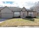 Charming brick front exterior with attached garage and well-manicured lawn in residential neighborhood at 18357 Piers End Dr, Noblesville, IN 46062