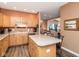 Open-concept kitchen features wood cabinets, island with seating and adjacent dining area at 18357 Piers End Dr, Noblesville, IN 46062