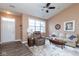 Bright living room boasts new wood flooring, a ceiling fan, large windows, and comfortable seating at 18357 Piers End Dr, Noblesville, IN 46062