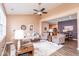 Spacious living room with wood floors, ceiling fan, and view into kitchen, dining, and seating areas at 18357 Piers End Dr, Noblesville, IN 46062