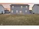 Back of house at sunset with a yard and neutral siding at 1854 Cascades Dr, Greenfield, IN 46140