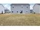 Back of house showing sliding glass doors and neutral siding at 1854 Cascades Dr, Greenfield, IN 46140