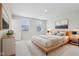 Cozy bedroom featuring a wooden bed frame, neutral bedding, and a window with blinds at 1854 Cascades Dr, Greenfield, IN 46140