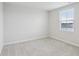 A bright, carpeted bedroom with one window and fresh neutral paint at 1854 Cascades Dr, Greenfield, IN 46140