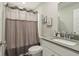 Well-lit bathroom featuring modern sink, gray countertop, and shower with curtain at 1945 Clement St, Westfield, IN 46074