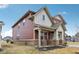 Side view of a two-story home with covered porch and brick foundation, set on a well-manicured lawn at 1945 Clement St, Westfield, IN 46074