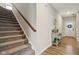Inviting home entryway with wood floors, staircase, console table, and decor leading to the main living areas at 1945 Clement St, Westfield, IN 46074