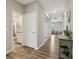 Hallway featuring wood floors, white doors and trim, and an open view to the spacious living area at 1945 Clement St, Westfield, IN 46074