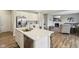 Open-concept kitchen with center island, stainless steel appliances, and connection to the living room at 1945 Clement St, Westfield, IN 46074