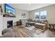 Comfortable living room featuring a fireplace, large gray sectional sofa, and natural light from two windows at 1945 Clement St, Westfield, IN 46074