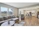 Bright and open living area with a large sectional sofa and view into kitchen with breakfast bar seating at 1945 Clement St, Westfield, IN 46074