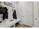 Welcoming mudroom features coat hooks, a bench, and neutral tones for a clean, organized entry from the garage at 1945 Clement St, Westfield, IN 46074