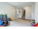 Bright playroom with carpet and view to stairs and kitchen at 1945 Clement St, Westfield, IN 46074