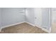 Clean, minimalist bedroom featuring modern laminated flooring, and neutral-toned walls with a window at 2040 Laurel St, Indianapolis, IN 46203