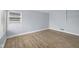 Bright bedroom with laminated floors, neutral walls, baseboard trim, and a window offering natural light at 2040 Laurel St, Indianapolis, IN 46203
