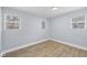 Bright bedroom featuring wood-look floors and two windows at 2040 Laurel St, Indianapolis, IN 46203