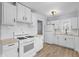 Modern kitchen featuring white cabinetry, wood countertops, and contemporary appliances, offering a clean aesthetic at 2040 Laurel St, Indianapolis, IN 46203