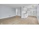 Open-concept living space with laminated flooring, white trim, complemented by an adjacent, updated kitchen at 2040 Laurel St, Indianapolis, IN 46203