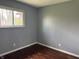 Small bedroom featuring hardwood floors, neutral-colored walls, and natural light from a window at 2346 Mayfair Dr, Indianapolis, IN 46260