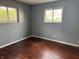 Cozy bedroom featuring hardwood floors, neutral-colored walls, and natural light from two windows at 2346 Mayfair Dr, Indianapolis, IN 46260