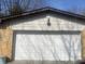 Close-up of a white garage door with a brick exterior, offering secure parking and storage at 2346 Mayfair Dr, Indianapolis, IN 46260