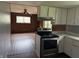 View from functional kitchen into another room; features white cabinets and stainless steel appliances at 2346 Mayfair Dr, Indianapolis, IN 46260